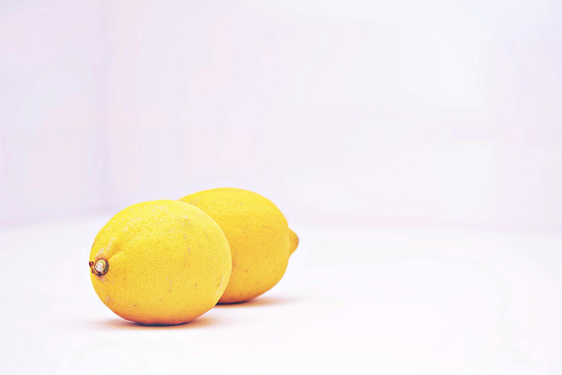Two vibrant lemons against a white background, symbolizing fresh approach to restoring pleasure