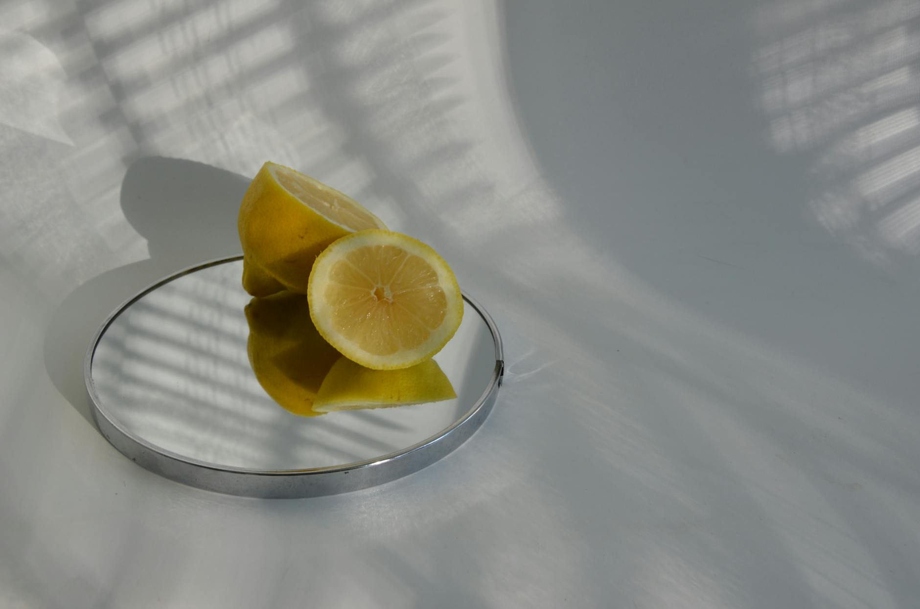 Two vibrant yellow lemons against a clean white background, symbolizing fresh approaches to pleasure