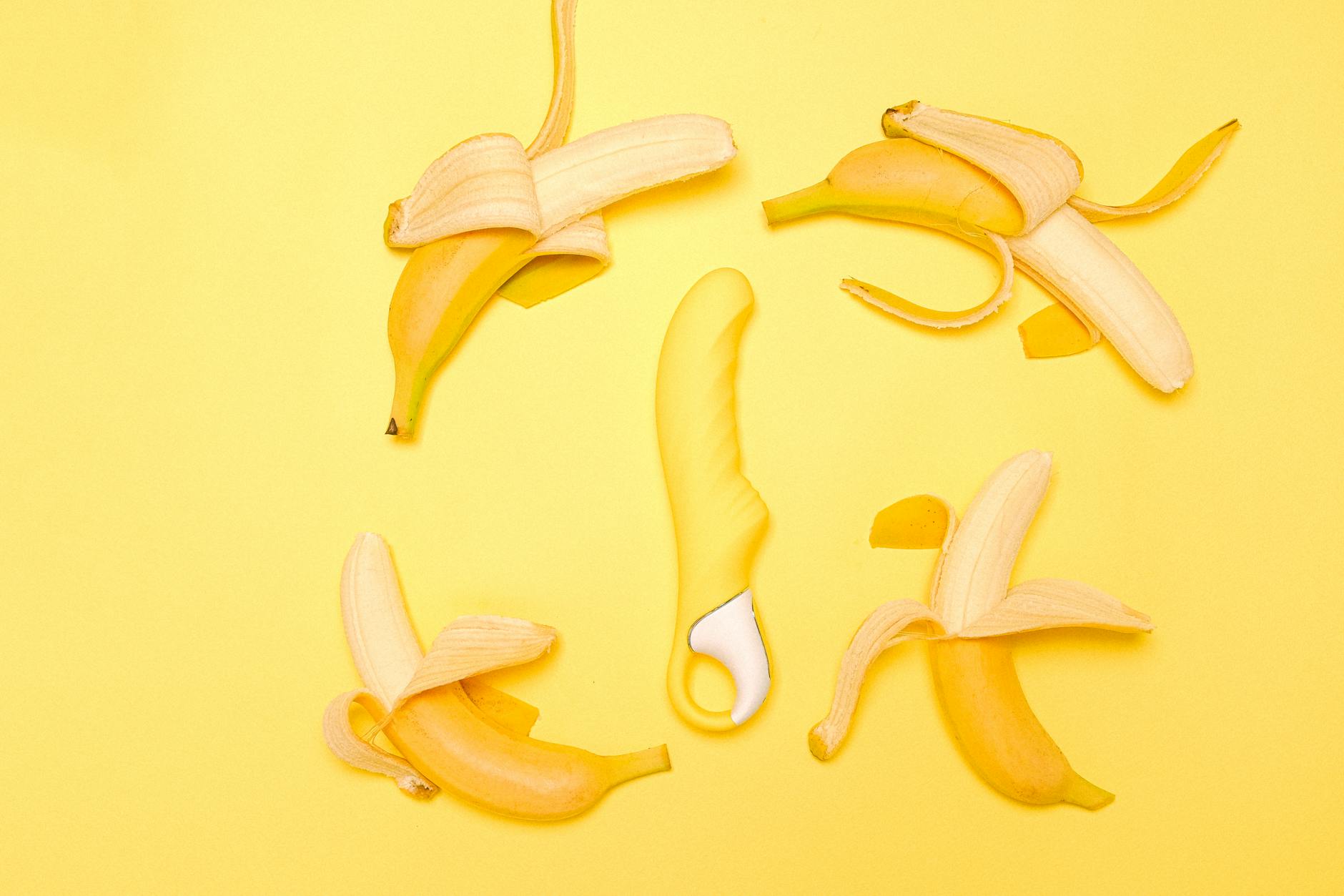 Yellow lemon-shaped clitoral vibrator on a soft yellow background, ready for intimate use