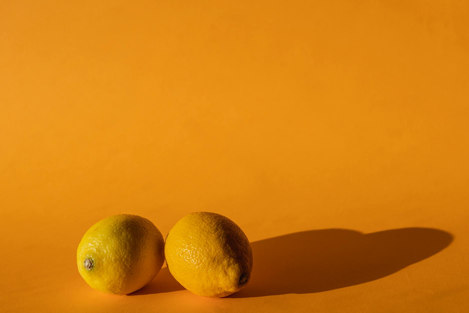 Bright lemons on a yellow background, representing renewal and fresh pleasure